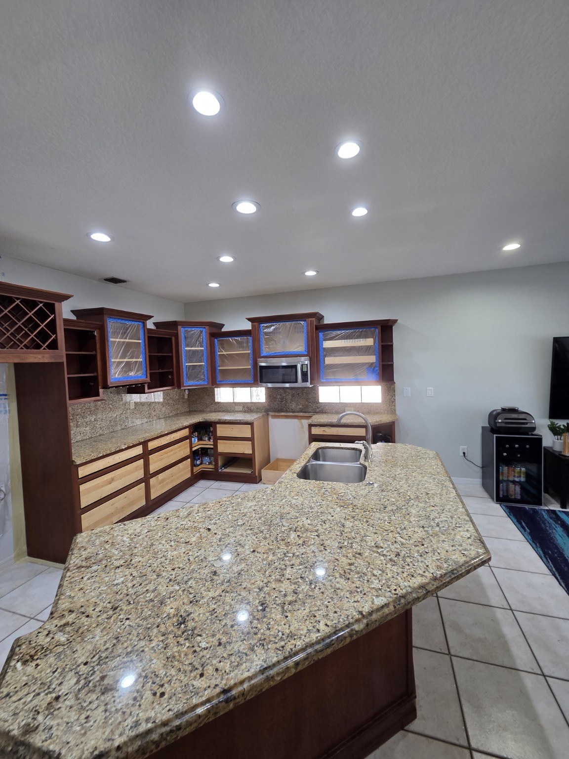 Before kitchen with brown cabinets and granite countertop