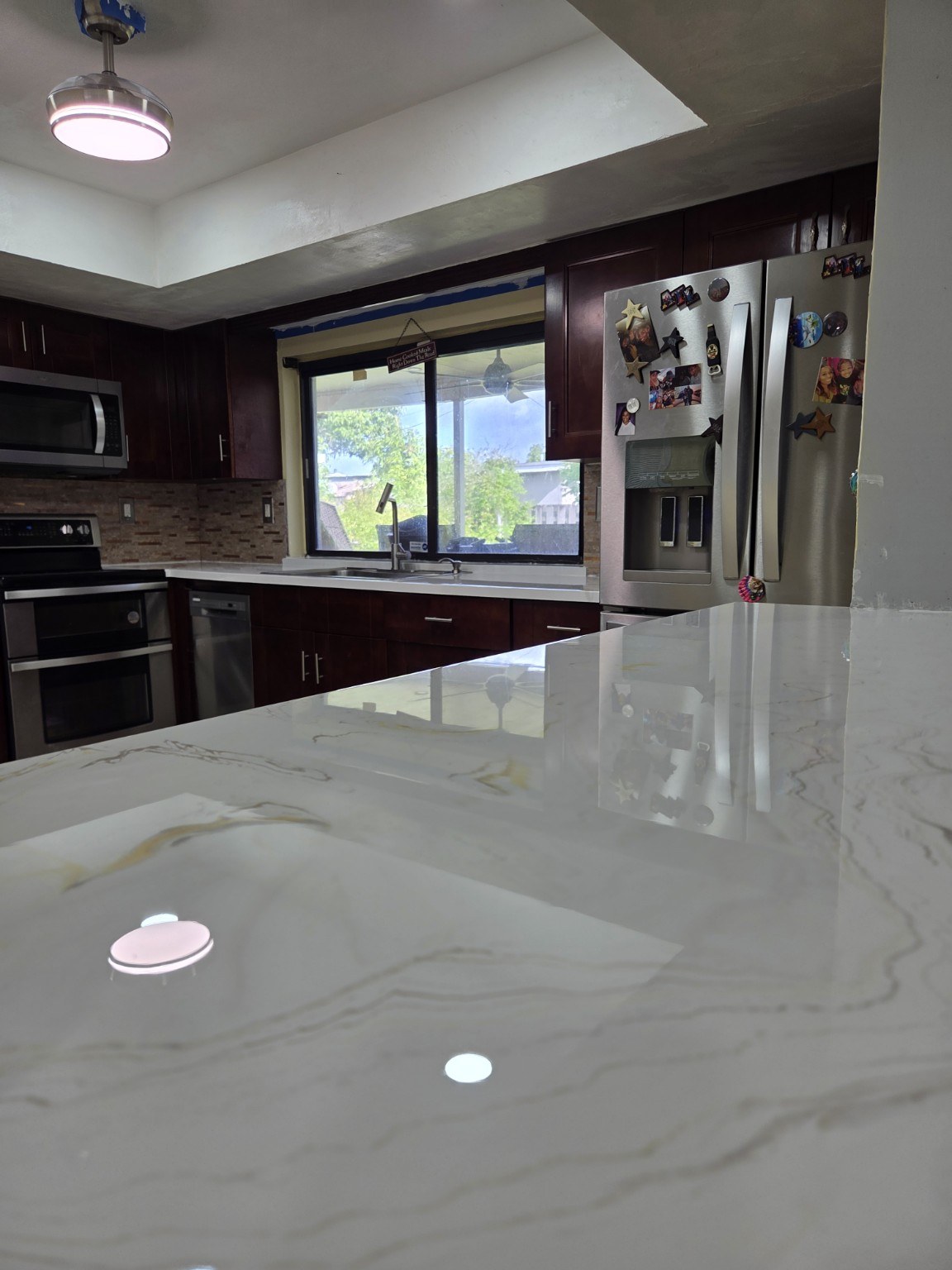 Close up of glossy white epoxy countertop with gray veins